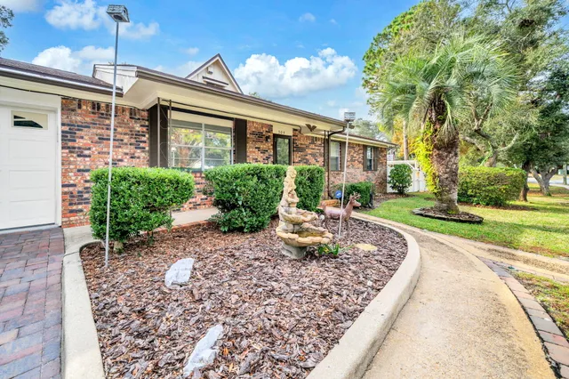 an empty room with a window and a ceiling fan