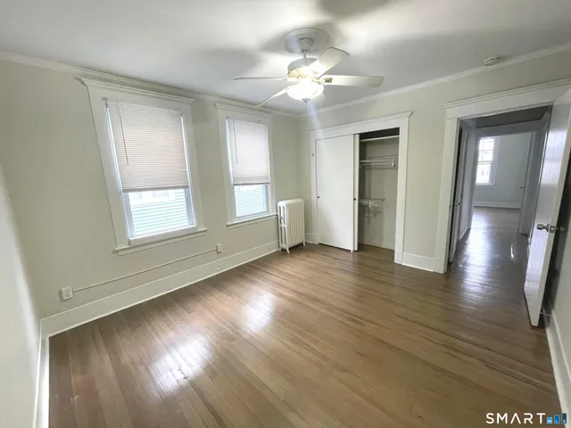 a bathroom with a sink mirror and a toilet
