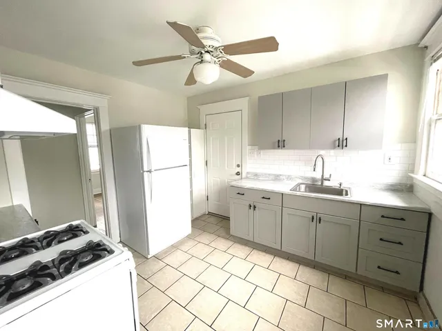 a kitchen with a sink appliances and cabinets