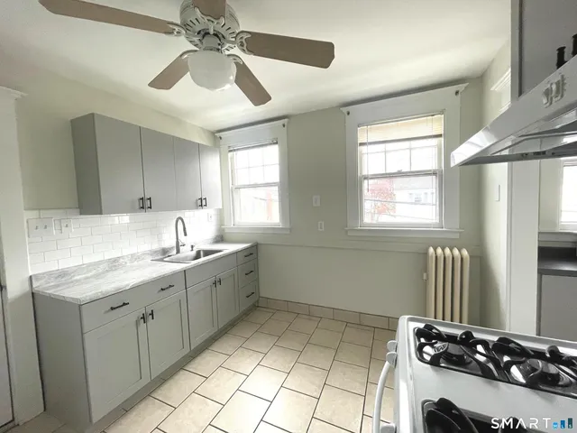 a kitchen with a sink appliances and cabinets
