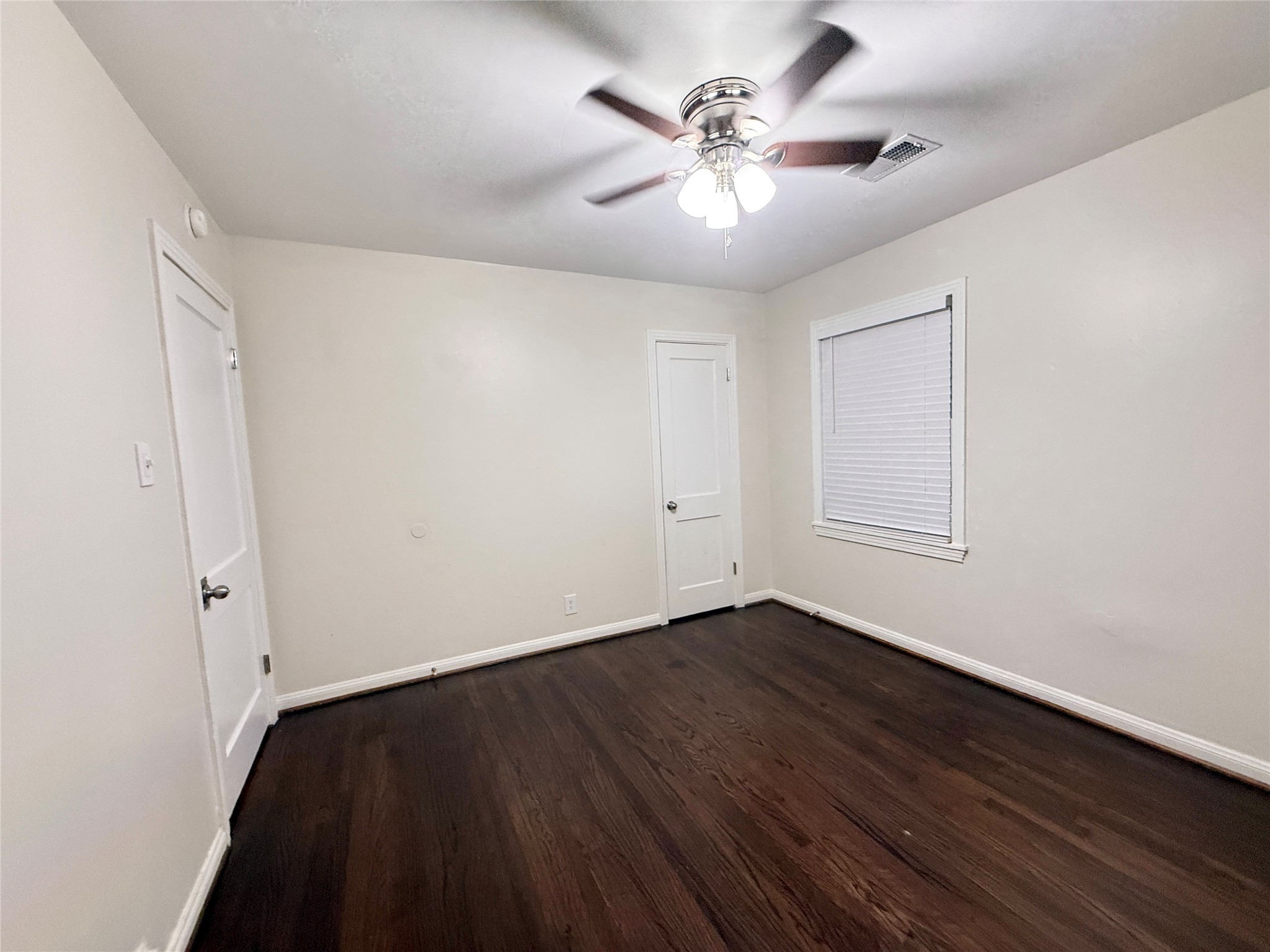 1232 San Felipe Street Angleton, TX 77515 - Photo 12 of 16 an empty room with wooden floor and windows