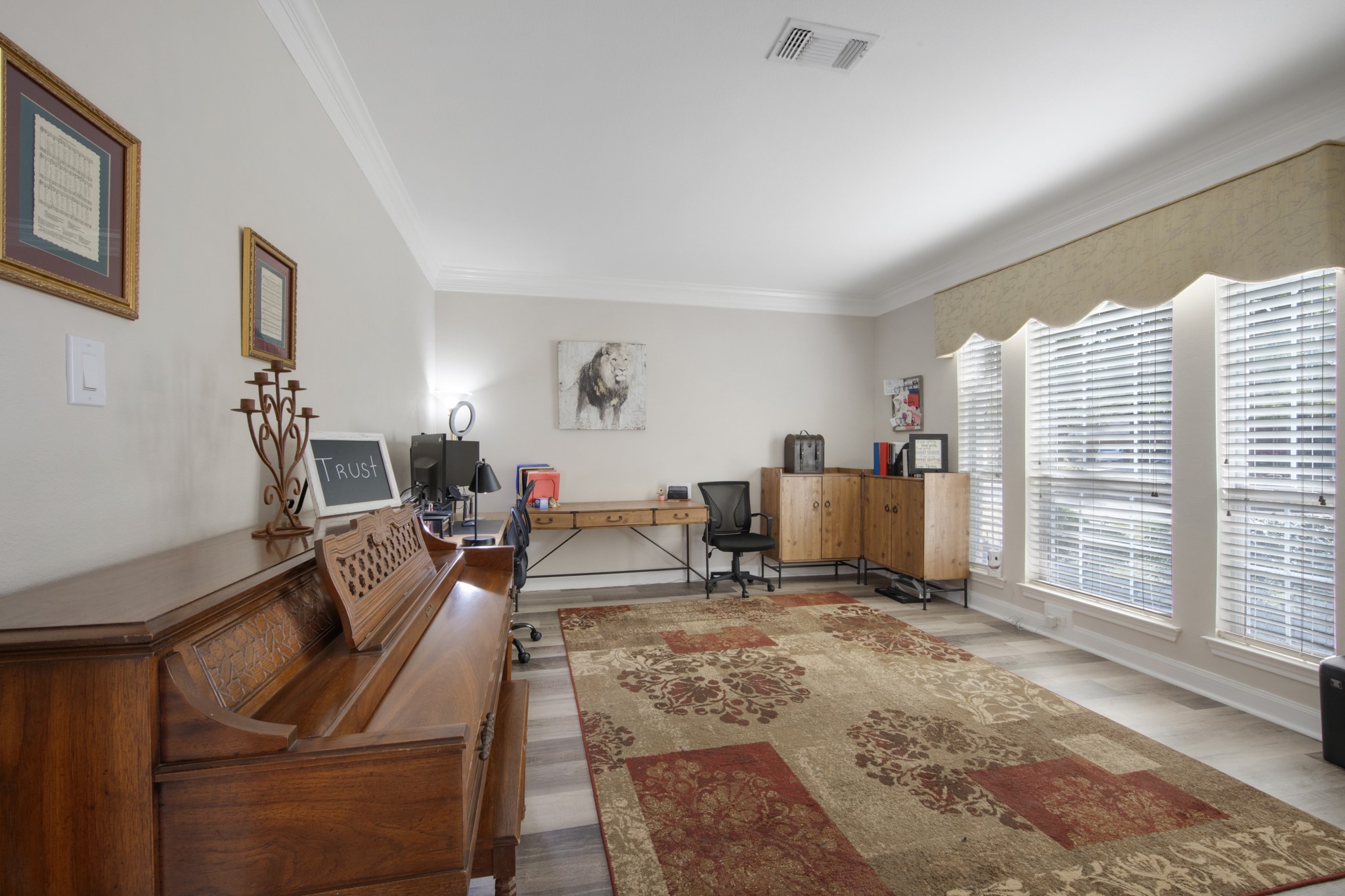 9510 Ashdown Forest Drive Spring, TX 77379 - Photo 12 of 50 HOME OFFICE/FORMAL LIVING – spacious office with large windows providing abundant natural light throughout the day. This flexible room offers the perfect setting for working from home, studying, or creating a quiet retreat.