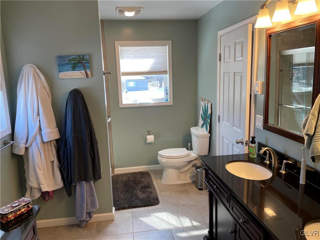 307 Gold Mill Road Wind Gap, PA 18091 - Photo 11 of 32 a bathroom with a sink a toilet and a mirror