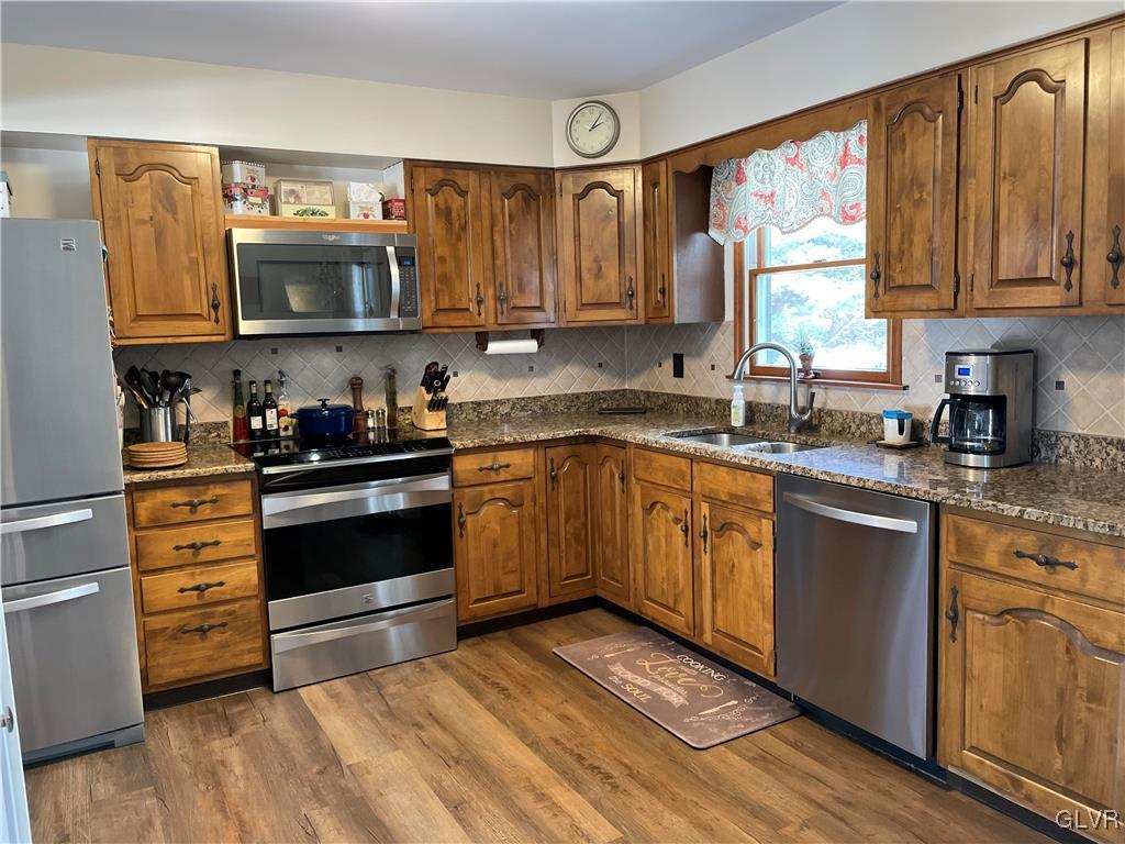 307 Gold Mill Road Wind Gap, PA 18091 - Photo 4 of 32 a kitchen with stainless steel appliances a stove microwave and cabinets