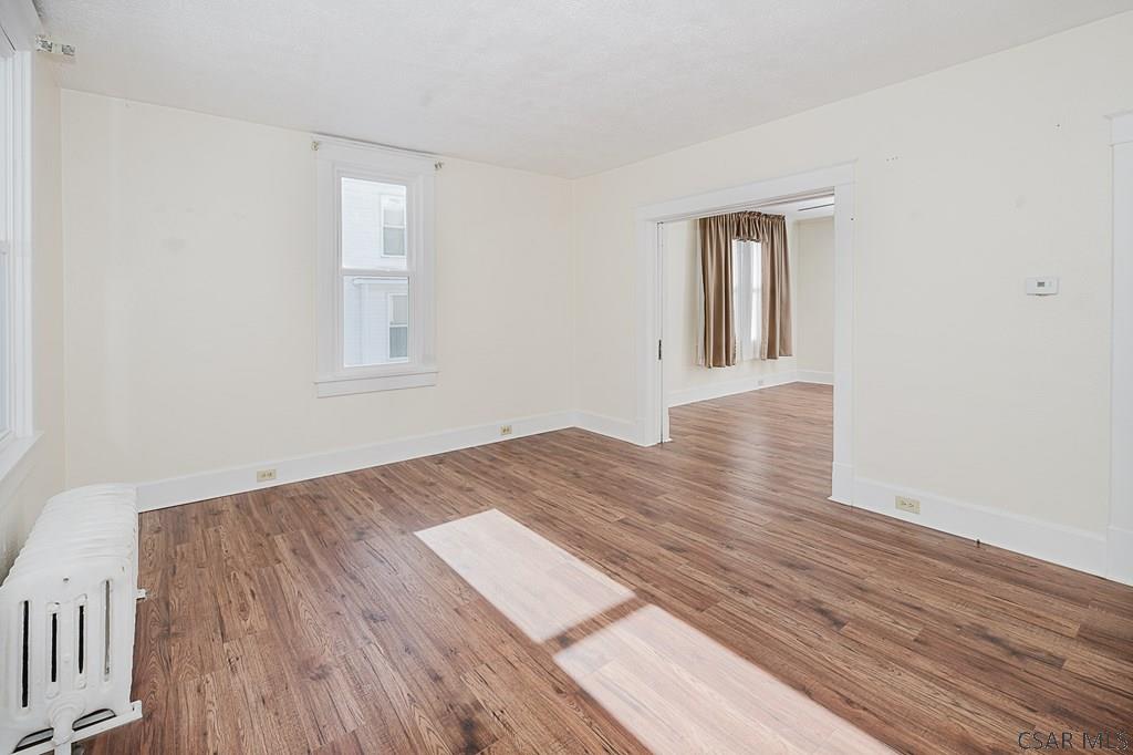 159 Wilson Street Johnstown, PA 15906 - Photo 7 of 27 a view of an empty room with wooden floor and a window