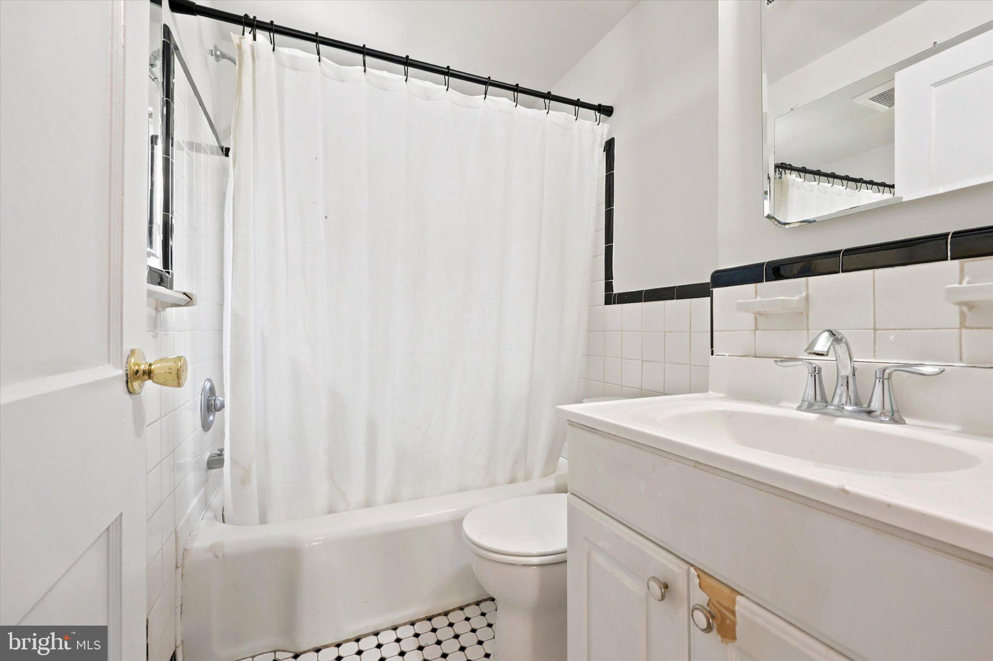 107 Plant Avenue Wayne, PA 19087 - Photo 4 of 15 Charming bathroom with classic tiles.