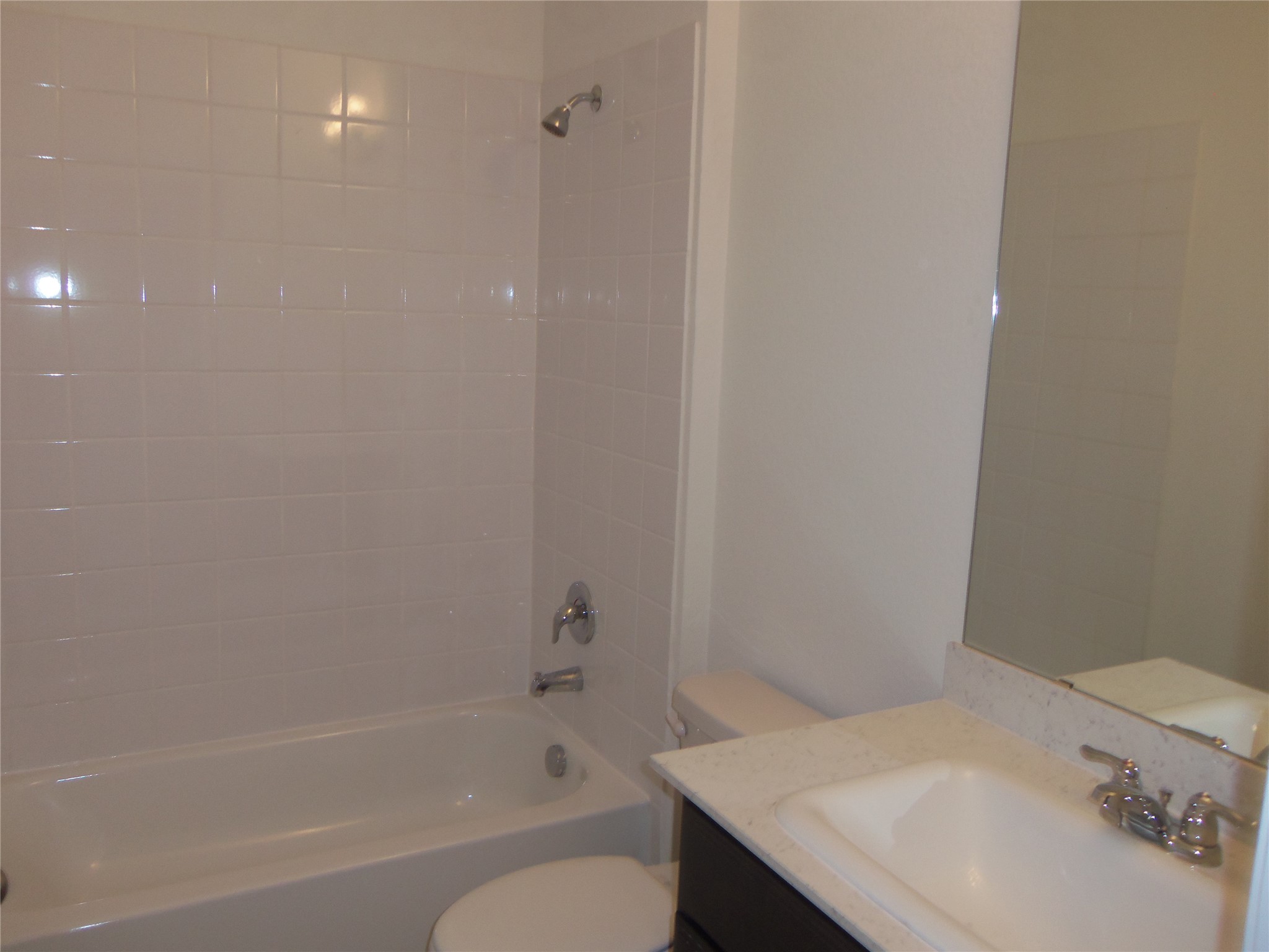 303 Cold Springs Loop Bastrop, TX 78602 - Photo 11 of 13 A well-appointed bathroom features a tub, shower, and convenient vanity with ample counter space.