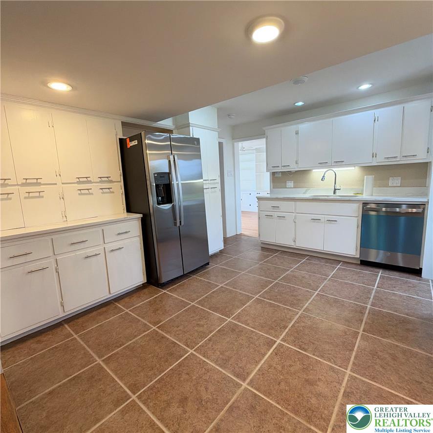 5111 Vera Cruz Road Emmaus, PA 18049 - Photo 18 of 44 Gleaming tile floors run throughout this functional kitchen design featuring abundant cabinet storage.