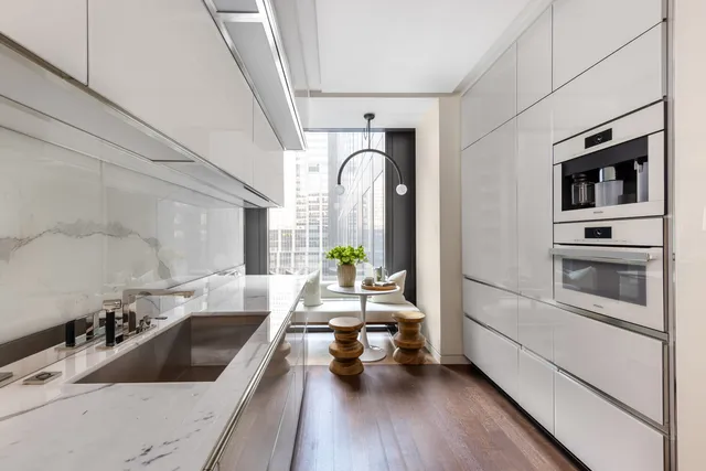 a living room with furniture a rug and white walls