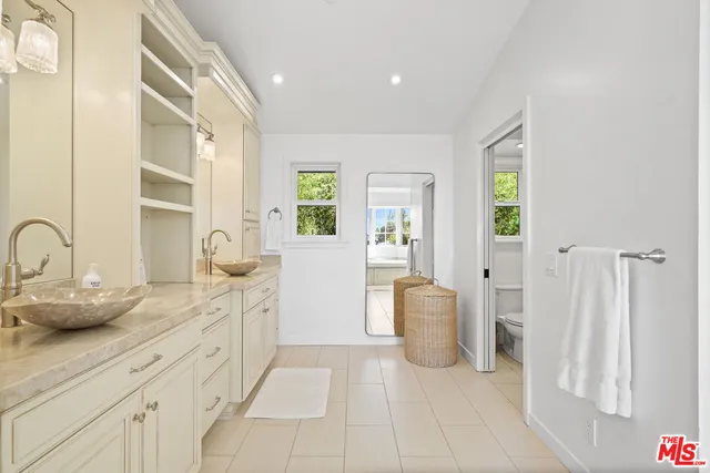 a spacious bathroom with a double vanity sink and a mirror
