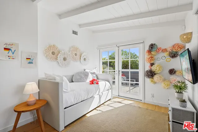 a bedroom with furniture and a window