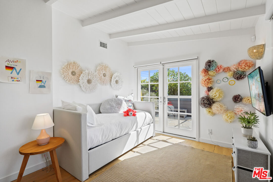 30081 Harvester Road Malibu, CA 90265 - Photo 17 of 33 a bedroom with furniture and a window