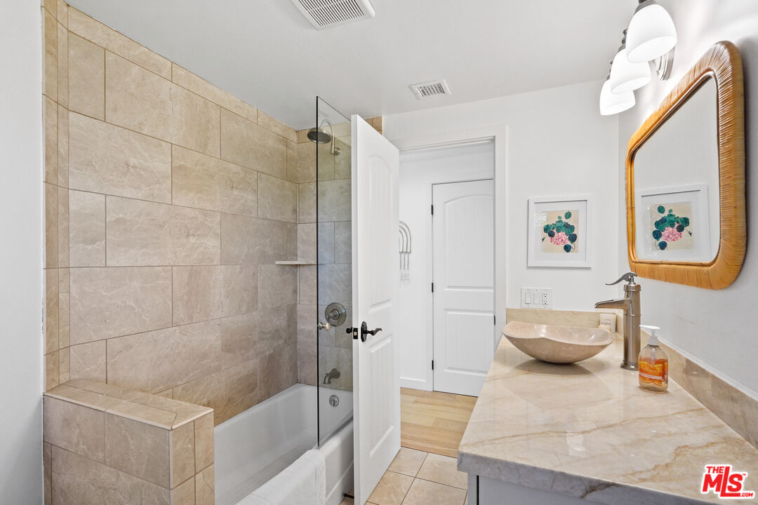 30081 Harvester Road Malibu, CA 90265 - Photo 20 of 33 a bathroom with a tub shower and toilet