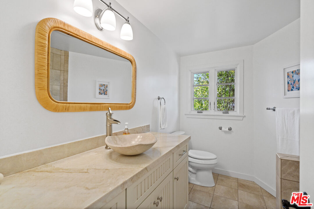 30081 Harvester Road Malibu, CA 90265 - Photo 21 of 33 a bathroom with a toilet sink and mirror