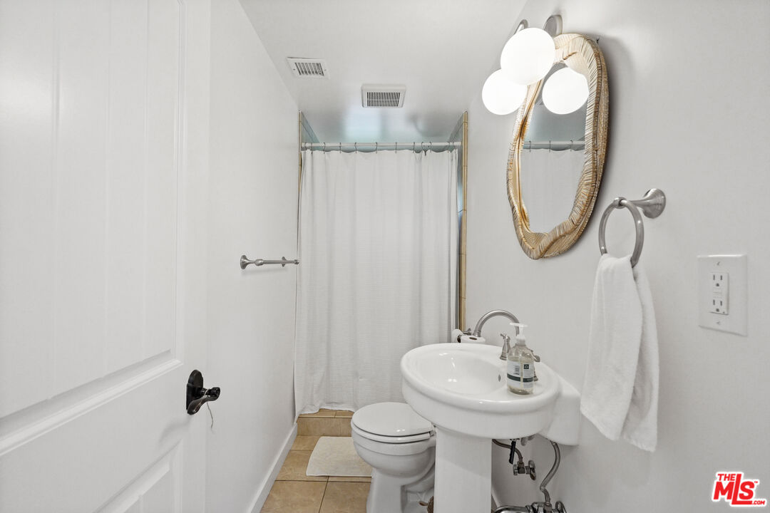 30081 Harvester Road Malibu, CA 90265 - Photo 23 of 33 a bathroom with a sink a toilet and a mirror