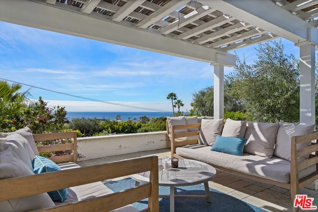 a outdoor living space with furniture and city view