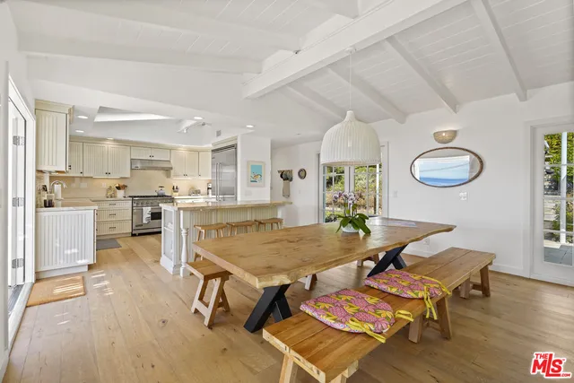 a living room with dining table and wooden floors