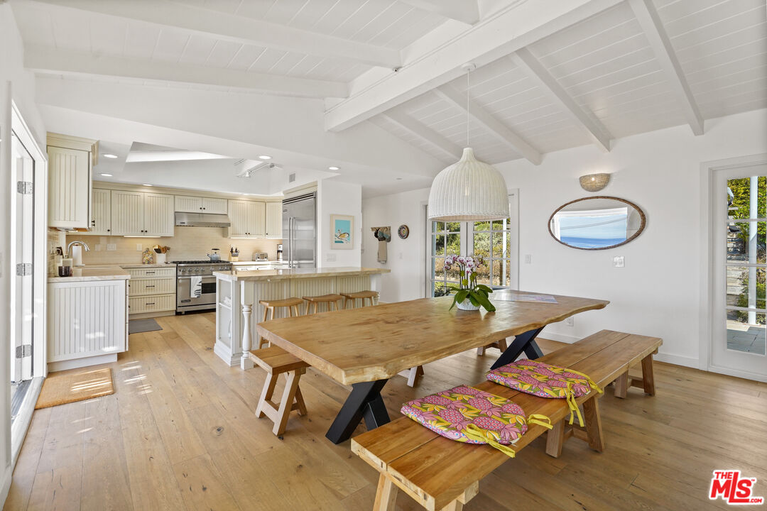 30081 Harvester Road Malibu, CA 90265 - Photo 6 of 33 a living room with dining table and wooden floors