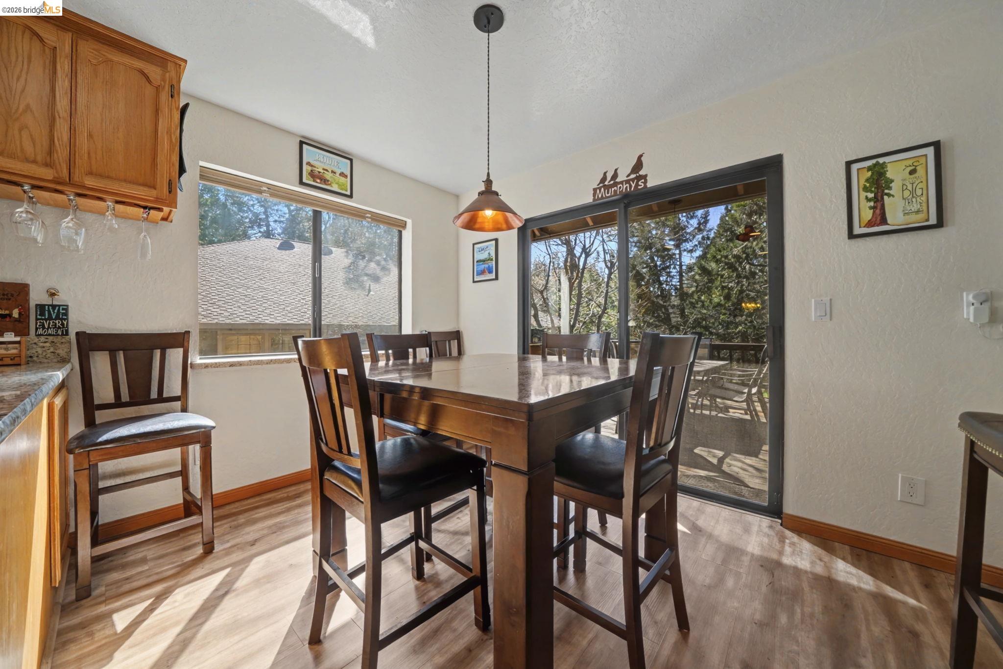 1554 Vine Maple Drive Murphys, CA 95247 - Photo 18 of 54 a dining room with furniture a chandelier and wooden floor