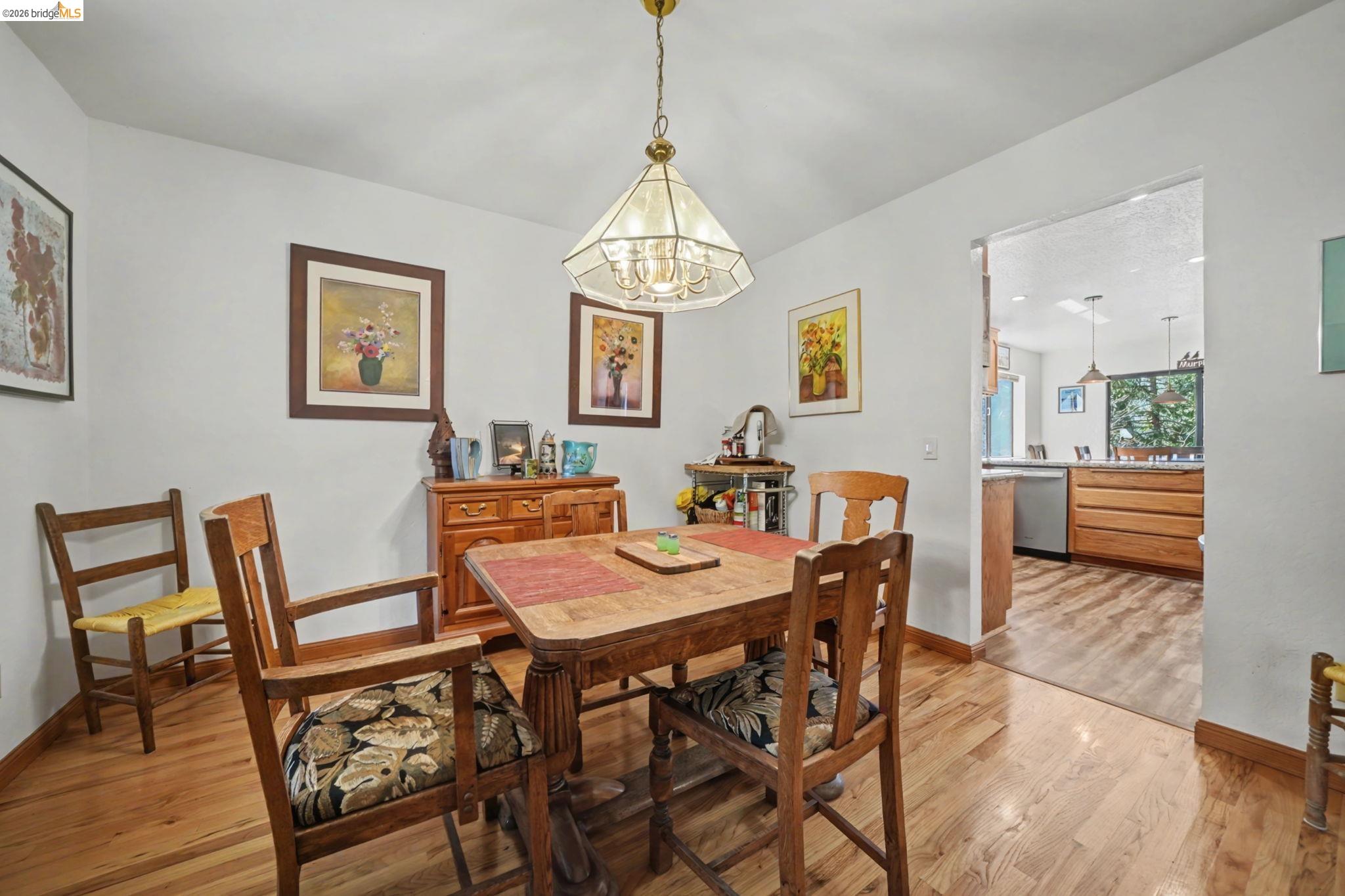 1554 Vine Maple Drive Murphys, CA 95247 - Photo 22 of 54 a view of a dining room with furniture wooden floor and a chandelier