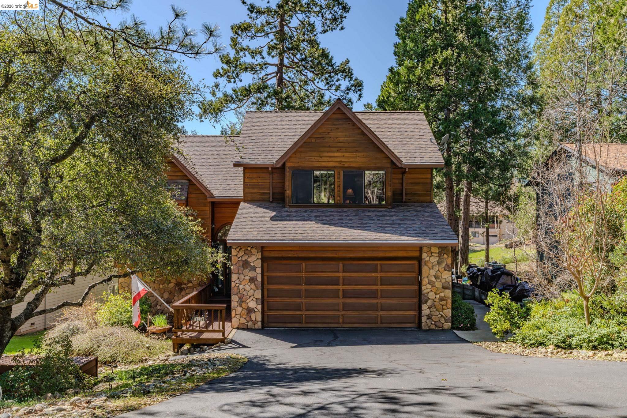 1554 Vine Maple Drive Murphys, CA 95247 - Photo 25 of 54 a front view of a house with a garage