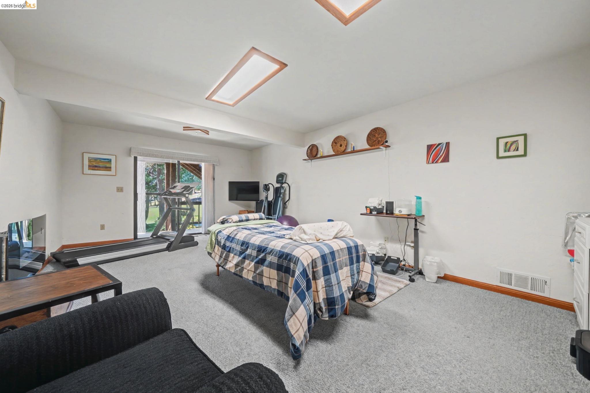 1554 Vine Maple Drive Murphys, CA 95247 - Photo 37 of 54 a bedroom with a bed couch and a window