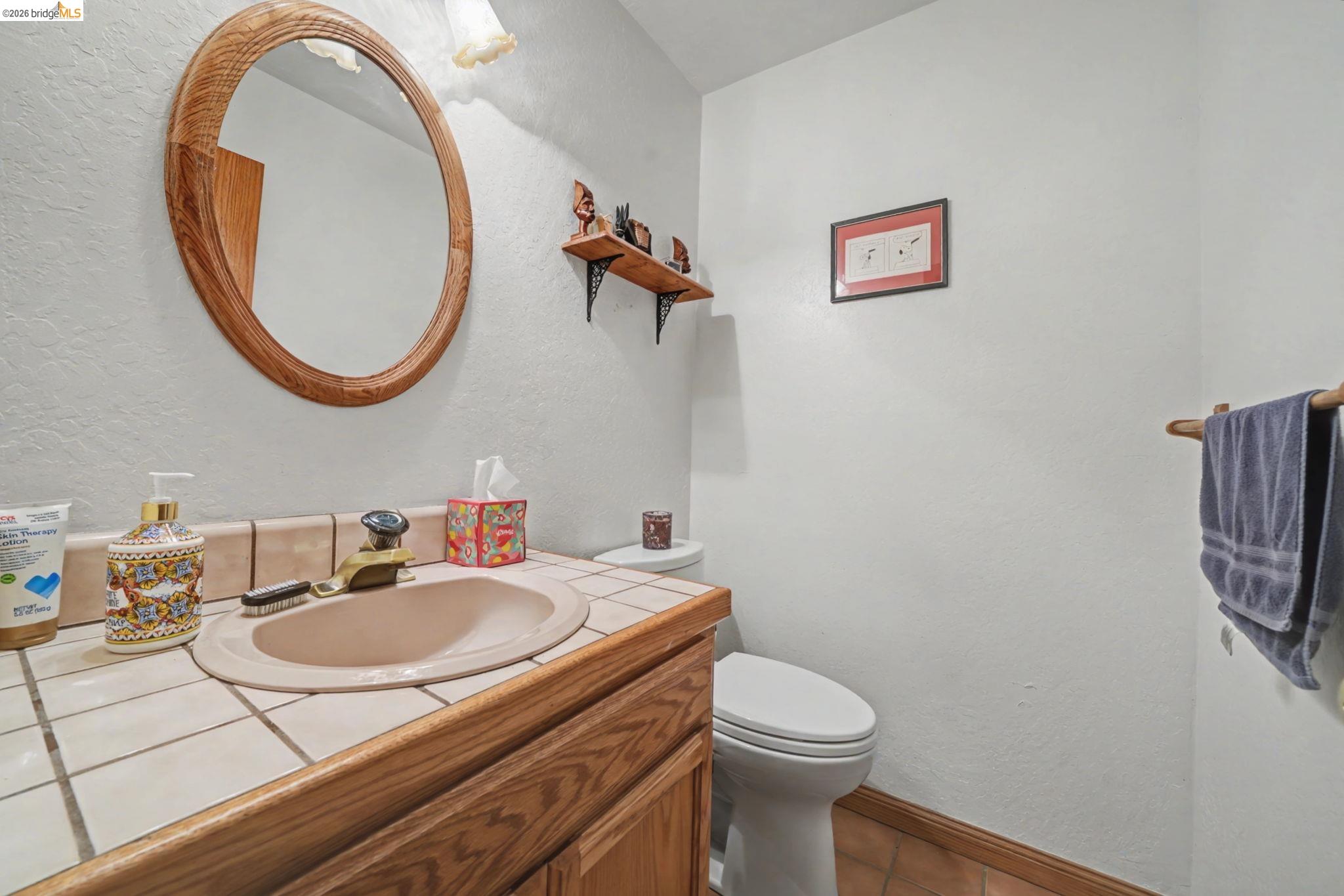 1554 Vine Maple Drive Murphys, CA 95247 - Photo 38 of 54 a bathroom with a sink mirror and toilet