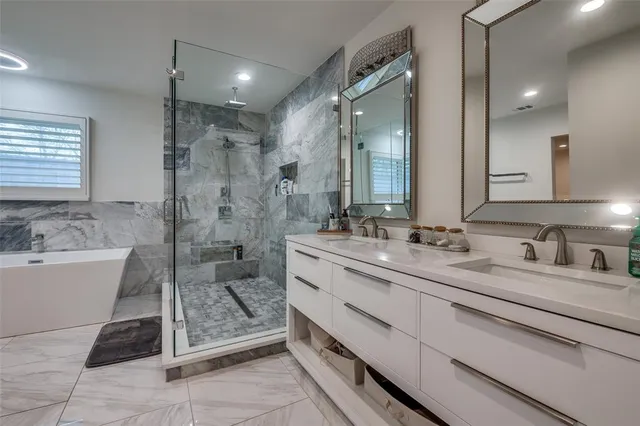 a bath room with a bath tub and a shower