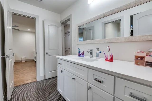 a spacious bedroom with a bed and a chandelier