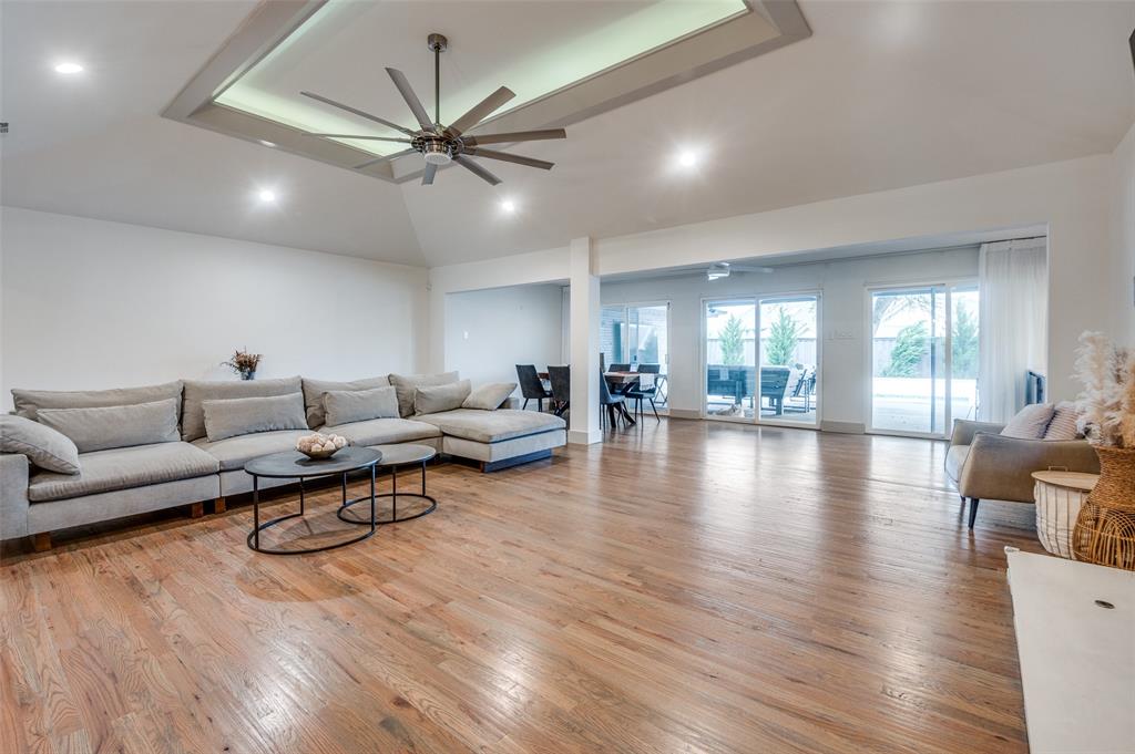 a living room with furniture or wooden floor and a ceiling fan