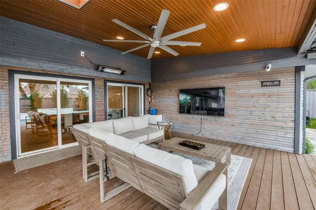 a living room with patio furniture and a wooden floor