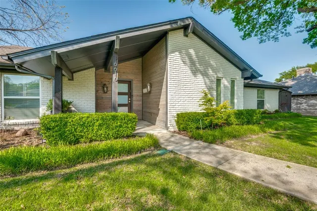 an aerial view of residential houses with outdoor space and river