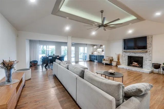 a living room with furniture or wooden floor and a ceiling fan