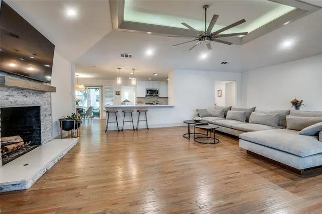 a living room with furniture a fireplace and a flat screen tv