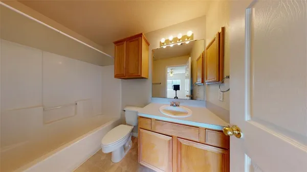 a bathroom with a sink a toilet a mirror and vanity