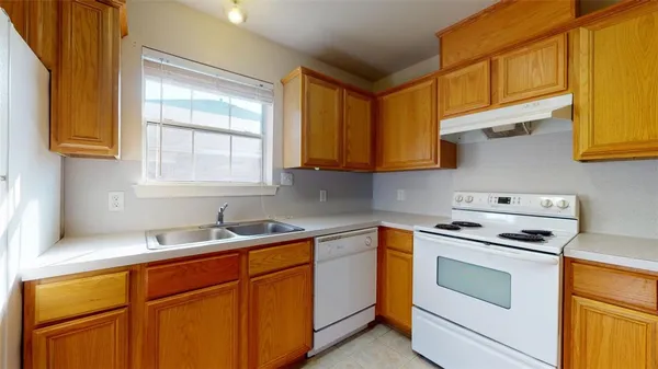 a kitchen with stainless steel appliances a stove a sink and a microwave