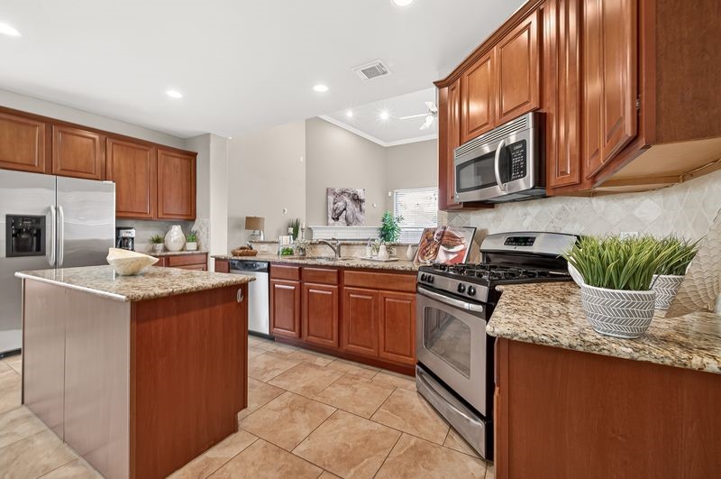 111 South Rocky Point Circle Spring, TX 77389 - Photo 12 of 41 a kitchen with stainless steel appliances granite countertop a stove sink microwave and cabinets