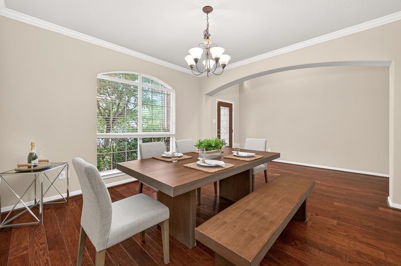 111 South Rocky Point Circle Spring, TX 77389 - Photo 7 of 41 a view of a dining room with furniture a chandelier and wooden floor