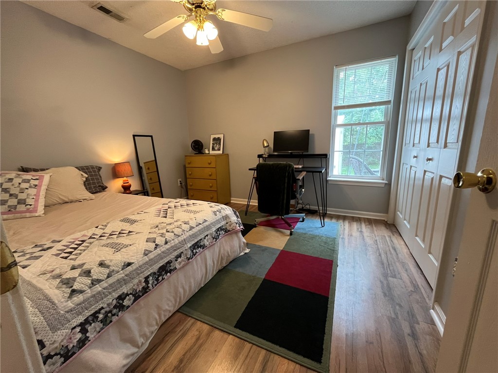 116 Arbors Court Central, SC 29630 - Photo 22 of 27 A comfortable bedroom features warm wooden-toned flooring and a convenient bi-fold closet.