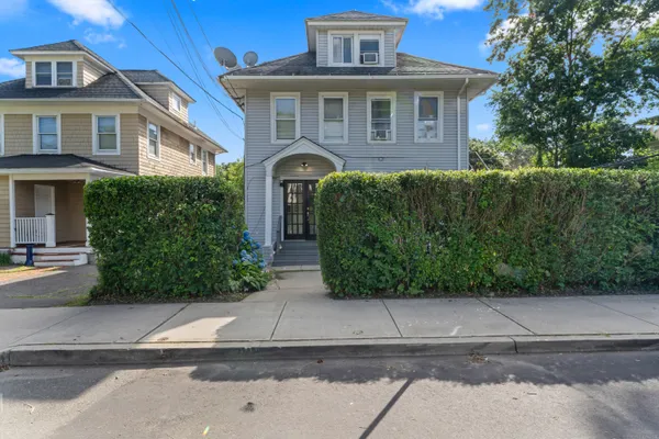 a front view of a house with a garden