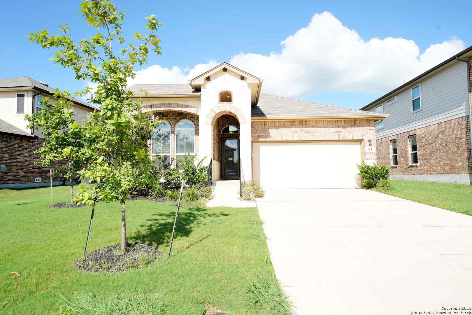 244 Albarella Cibolo, TX 78108 - Photo 1 of 1 a front view of a house with a yard and garage
