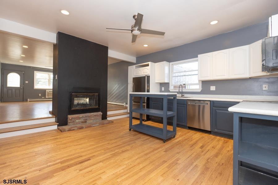 30 South Old Tuckahoe Road Marmora, NJ 08223 - Photo 18 of 35 a kitchen with stainless steel appliances kitchen island granite countertop a sink cabinets and wooden floor
