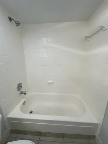 a white toilet sitting next to a bathroom sink