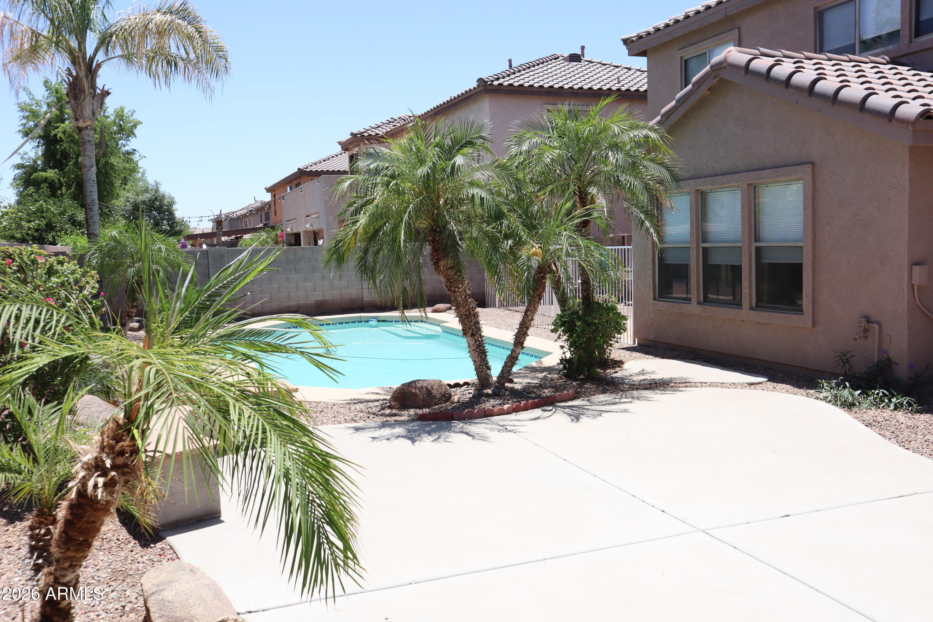 3281 South Martingale Road Gilbert, AZ 85297 - Photo 14 of 15 a vase of flowers sitting on a floor in front of a house