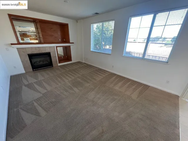 a utility room with wooden floor washer and dryer
