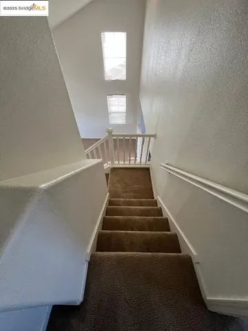 a view of a room with wooden floor and window