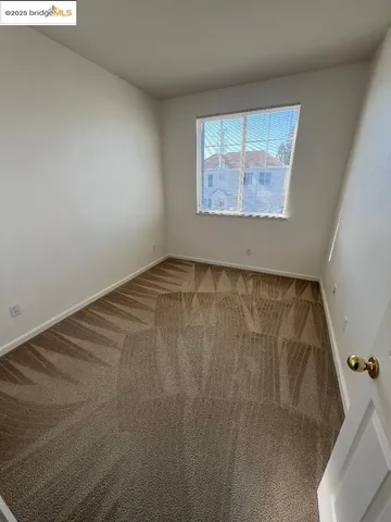 a view of an empty room and a window