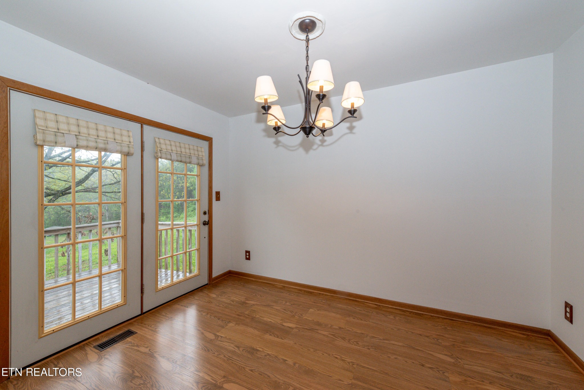 4038 Big Springs Ridge Road Friendsville, TN 37737 - Photo 7 of 26 a view of a room with wooden floor fan and windows