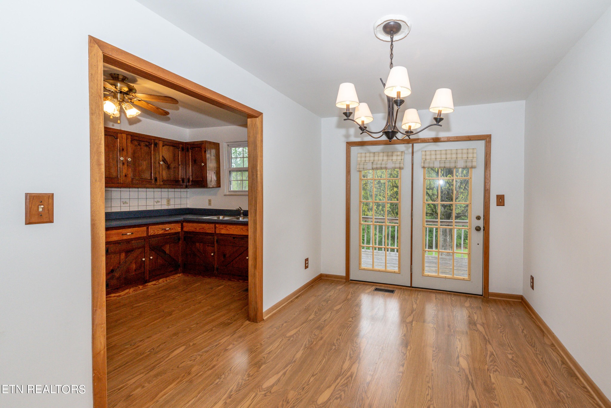 4038 Big Springs Ridge Road Friendsville, TN 37737 - Photo 8 of 26 a view of a room with wooden floor staircase and a chandelier