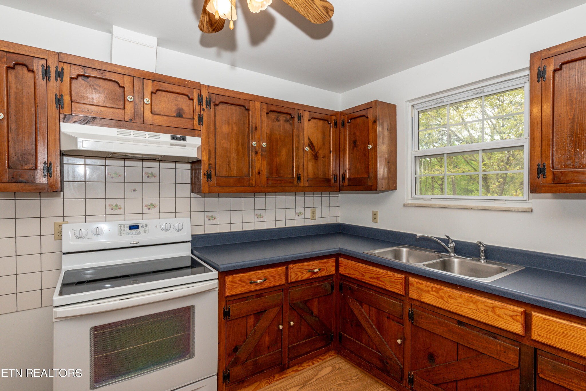 4038 Big Springs Ridge Road Friendsville, TN 37737 - Photo 9 of 26 a kitchen with granite countertop cabinets sink stove and microwave
